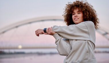 Woman standing outside at sunset stretching her arm across her body