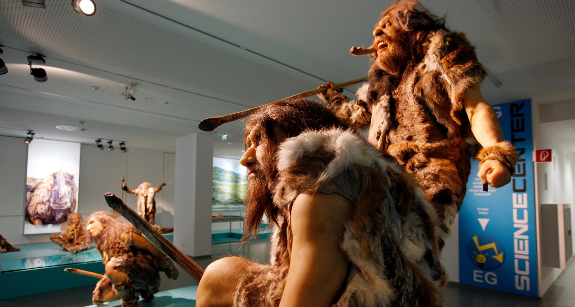 Three statues model how Neanderthals may have looked.