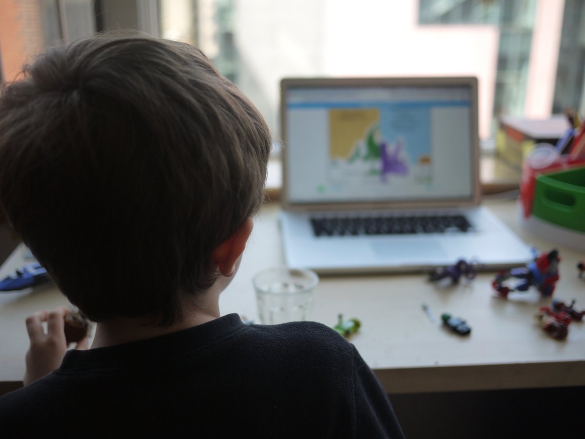 A young boy participates in an online 