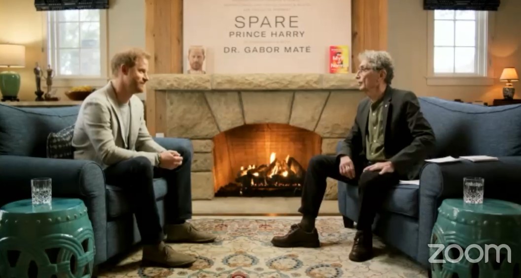 Prince Harry and Dr. Gabor Maté in conversation, with Harry's book "Spare" displayed above a fireplace.