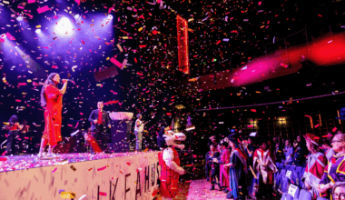 Performers on stage under confetti during the Northeastern London Convocation.