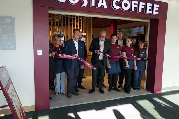 A ribbon cutting at the opening of the new Costa Coffee outlet.