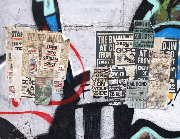 Posters were lined on the walls calling for action in Gotham