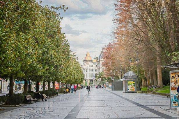 A pedestrian promenade by the park Campo de San Francisco in Oviedo, Spain.