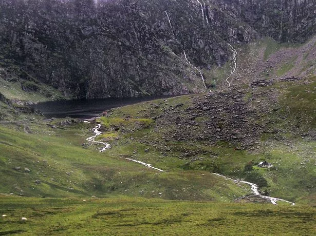 A lake at the bottom of a steep valley