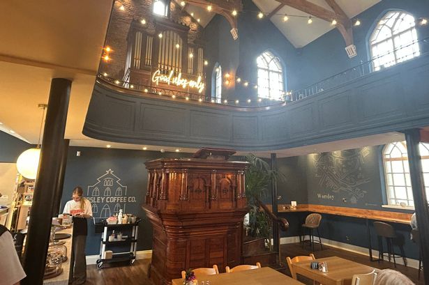 A church organ, boasting a neon sign saying 'Good Vibes Only', and a pulpit set the scene for a very uniquely located cafe