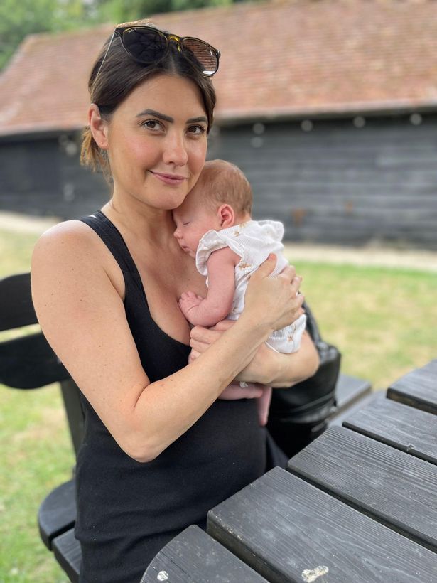 Aimee cuddles baby Charli