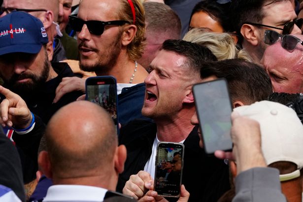 British far-right activist Tommy Robinson (C), whose real name is Stephen Yaxley-Lennon, shouts as he marches with supporters including actor and right-wing activist Laurence Fox (CL) through central London during a 'Free speech' march