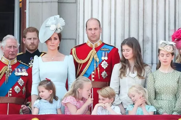 Members of the Royal Family (L-R) Britain's Prince Charles, Prince of Wales, Britain's Prince Harry, Britain's Catherine, Duchess of Cambridge (with Princess Charlotte, Savannah Phillips, Prince George) and Britain's Prince William, Duke of Cambridge, stand on the balcony of Buckingham Palace to watch a fly-past of aircraft by the Royal Air Force, in London on June 9, 2018. The ceremony of Trooping the Colour is believed to have first been performed during the reign of King Charles II. In 1748, it was decided that the parade would be used to mark the official birthday of the Sovereign. More than 600 guardsmen and cavalry make up the parade, a celebration of the Sovereign's official birthday, although the Queen's actual birthday is on 21 April. (Photo by Daniel LEAL / AFP) (Photo by DANIEL LEAL/AFP via Getty Images)