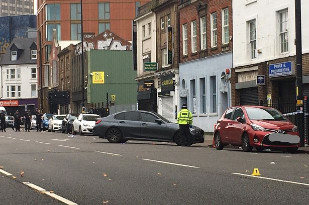 Forensic markers placed on the street on Saturday after the shooting