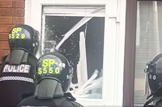 Windows and doors were smashed in by cops in riot gear