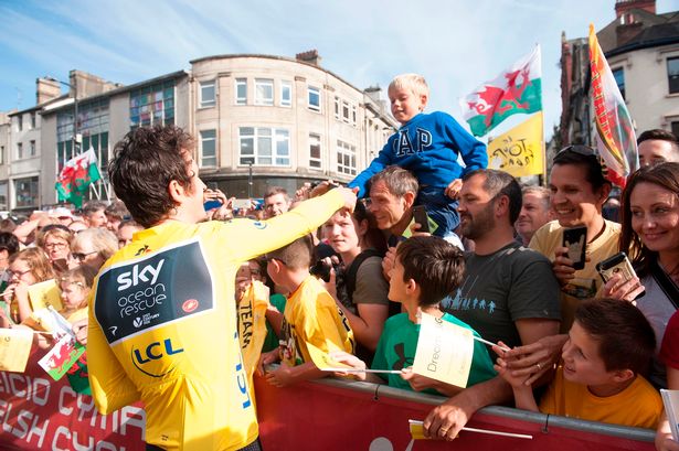 Thomas, in his yellow lycra, greets fans at Castle Street, Cardiff