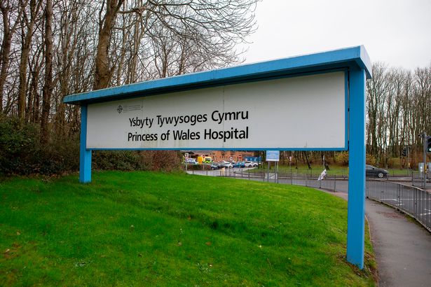The image shows a wide shot of a generic picture of the sign outside the front of the Princess of Wales Hospital