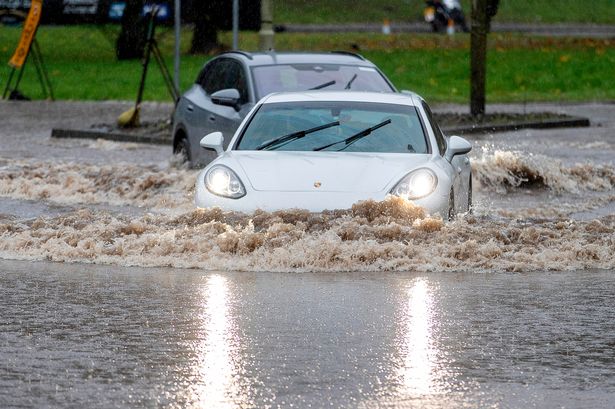 Car driving through flooded road