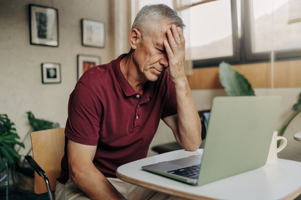Concerned older person checking their laptop