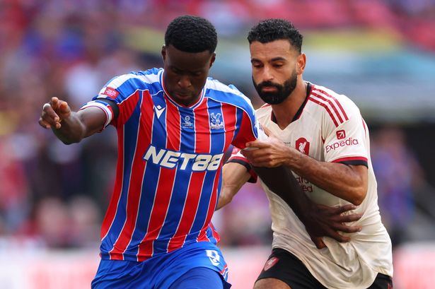Marc Guehi of Crystal Palace under pressure from Mohamed Salah of Liverpool