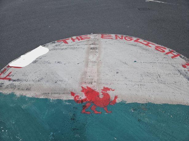A Welsh flag has been painted on a roundabout with an offensive message, after an England flag was painted on it last week