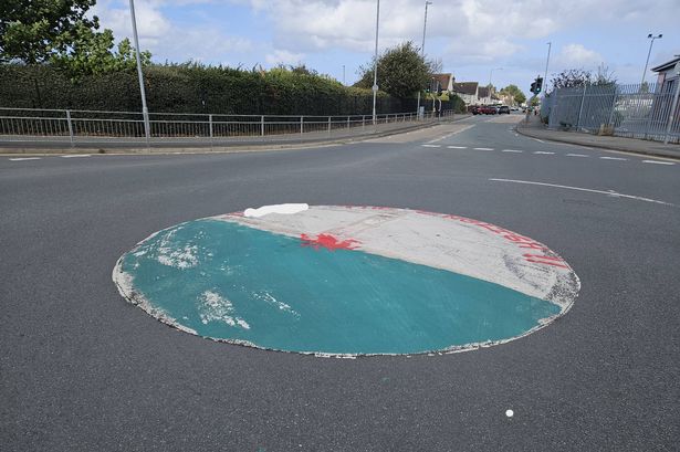 The Welsh flag with an offensive slogan on a roundabout