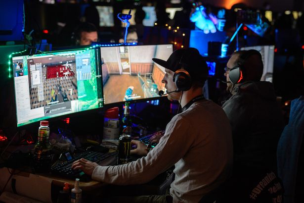 Participants sit at computer monitors to play video games at the 2018 DreamHack video gaming festival