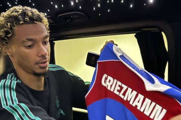 Hugo Ekitike admires Antoine Griezmann's shirt after swapping with his compatriot after Liverpool's win vs Atletico Madrid.