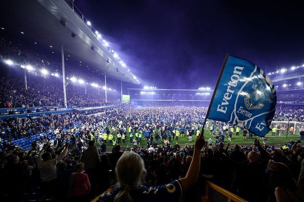 Everton's fans invade the football pitch to celebrate the win over Crystal Palace that secured Premier League survival in May 2022. Photo by Oli SCARFF/AFP 