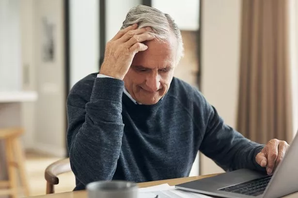 Man stressed with paperwork