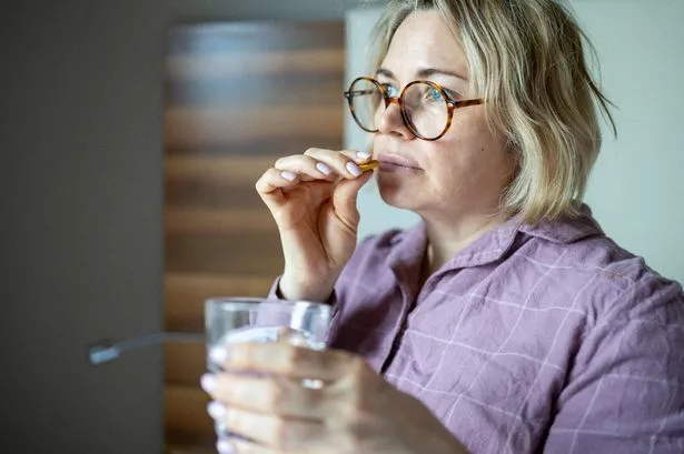 Woman taking supplement