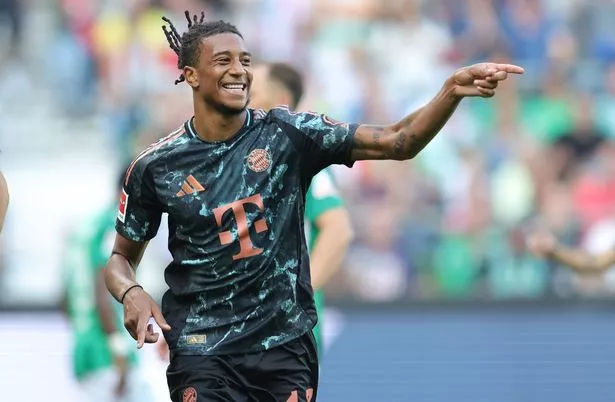 Michael Olise points and smiles on the pitch