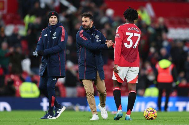 Manchester United head coach Ruben Amorim shakes hands with Kobbie Mainoo