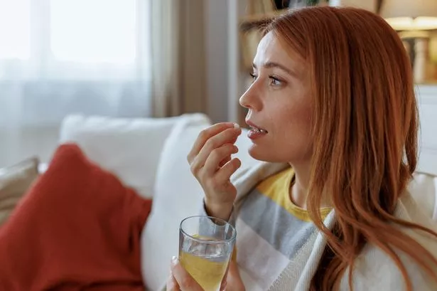 Woman taking tablet