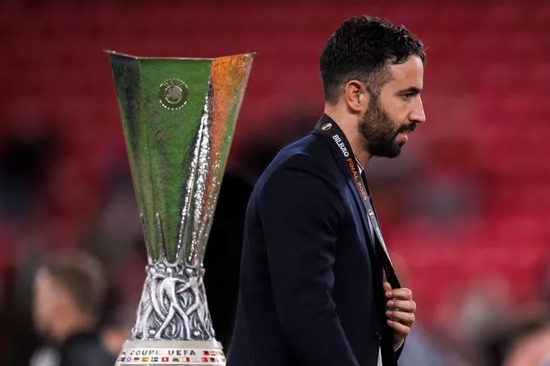Ruben Amorim walks past the Europa League trophy after Manchester United lost to Tottenham Hotspur in Bilbao