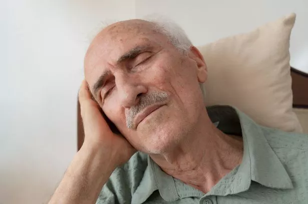 Man asleep in chair