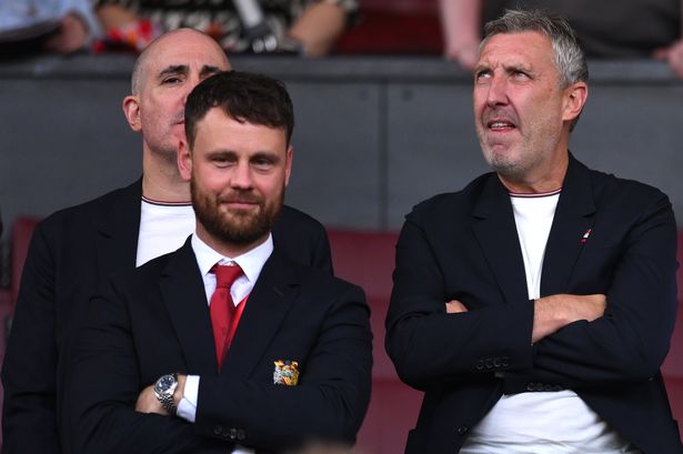 Berrada, Vivell and Wilcox in the Old Trafford directors' box