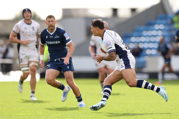 Louis Rees-Zammit of Bristol Bears runs at Rob Du Preez of Sale Sharks in his comeback game