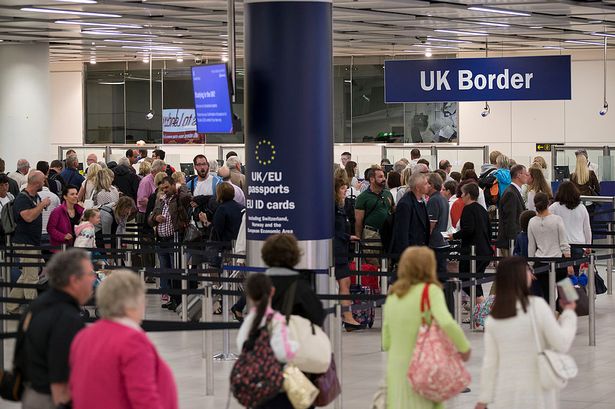 Border Force check the passports of passengers