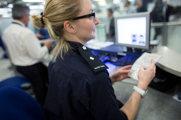 Border Force check the passports of passengers arriving at Gatwick Airport 