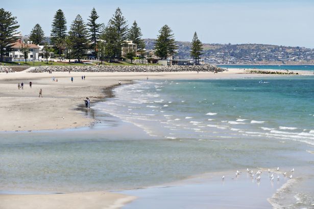 People enjoying themselves at Glenelg Beach on a spring day.