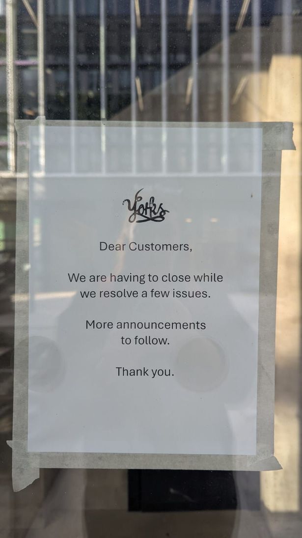 A closure sign in the window at Yorks