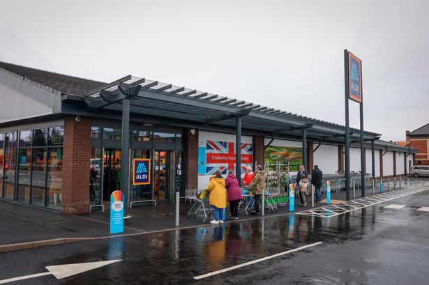 Aldi store with shoppers queuing outside 