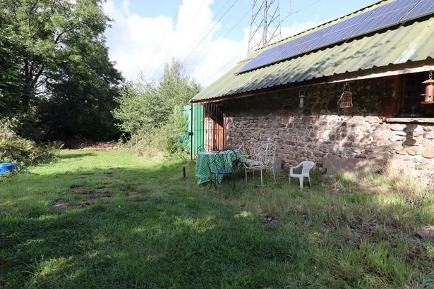 Seating area in land that comes with stone barn going to auction with guide price of £139,000 with Auction House Wales