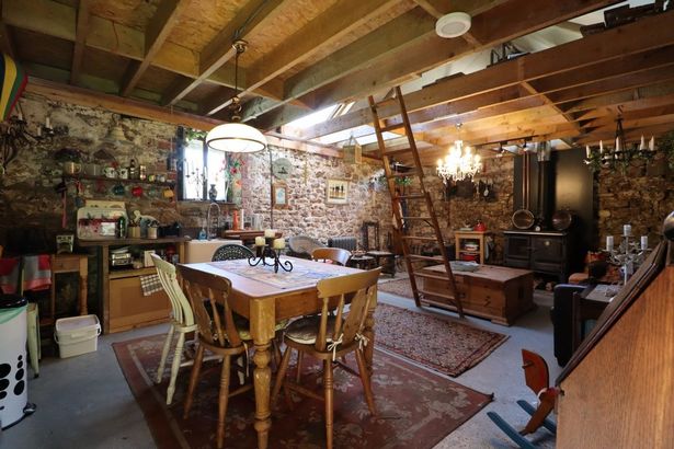 Inside the open-plan space with kitchen dining and lounge areas at a Stone Barn with Land totalling 0.79 acres between Cardiff and Caerphilly going to auction with guide price of £139,000 with Auction House Wales