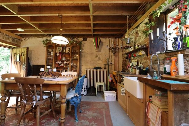Inside the open-plan space with kitchen dining and lounge areas at a Stone Barn with Land totalling 0.79 acres between Cardiff and Caerphilly going to auction with guide price of £139,000 with Auction House Wales