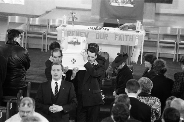 The funeral of James Bulger, Sacred Heart Church, Kirkby.  Ralph Bulger helps carry the coffin as his wife Denise follows. 1st March 1993.