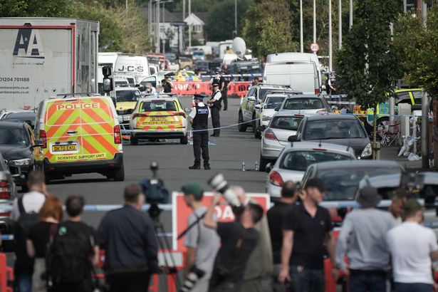 Members of the media gather as police and forensic officers attend the scene of the multiple stabbing attack on July 29, 2024 in Southport, England. The North West Ambulance Service says they were treating at least eight people for stab injuries after a reported attack near Hart Street. (Photo by Christopher Furlong/Getty Images)