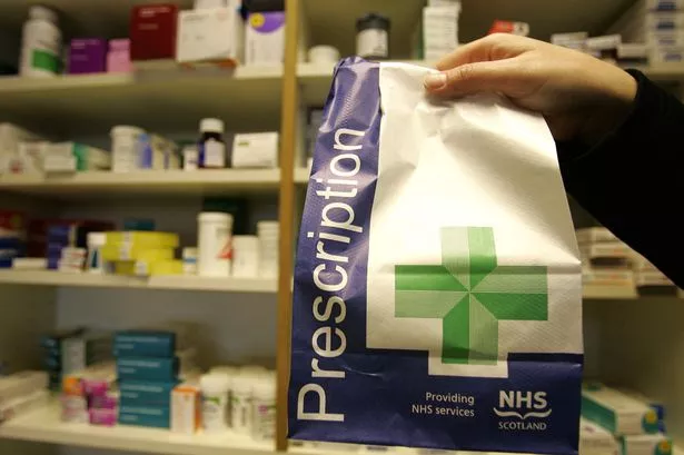 A prescription being picked up at a pharmacy
