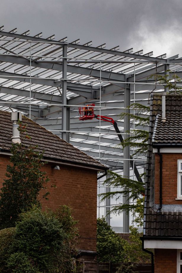 The towering steel structure imposes itself over the semi-detached homes in Wigan
