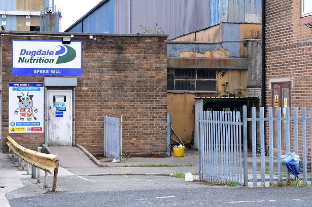 A bouquet of flowers left at Dugdale Nutrition in Speke where a man died after falling into an empty silo
