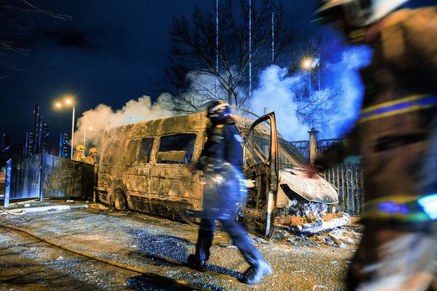 A burnt out police van outside the Suites Hotel in Knowsley in February 2023