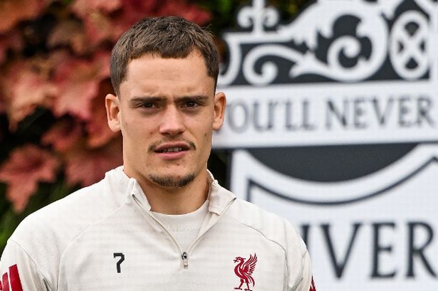 Florian Wirtz walking out in front of the Liverpool crest during training
