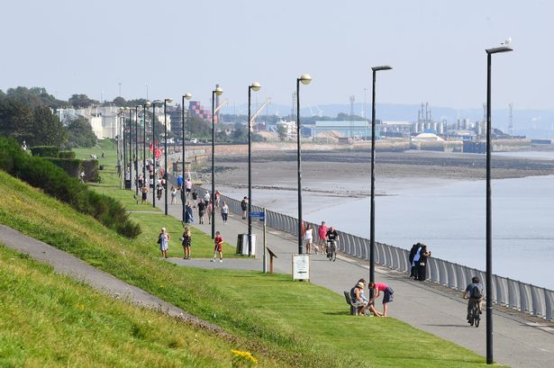 Families enjoying a walk in the sunshine on the Promenade at Otterspool